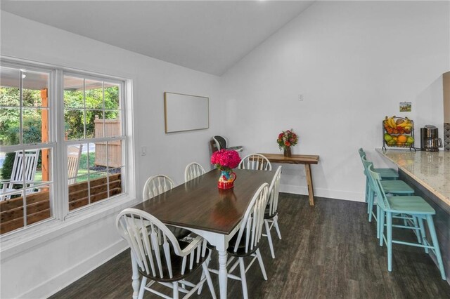 dining room with vaulted ceiling and dark hardwood / wood-style flooring