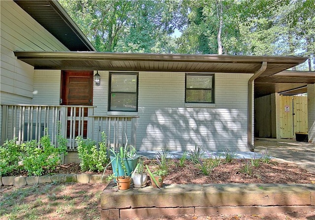 exterior space featuring a porch and brick siding