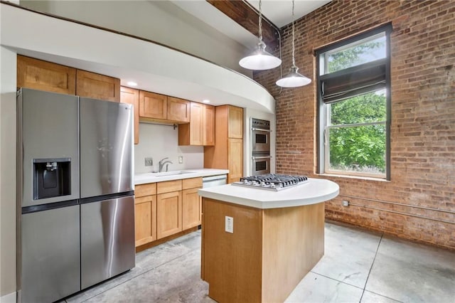 kitchen with stainless steel appliances, a high ceiling, concrete floors, and brick wall