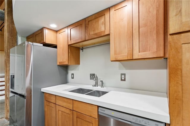 kitchen featuring a sink, light countertops, stainless steel appliances, and recessed lighting