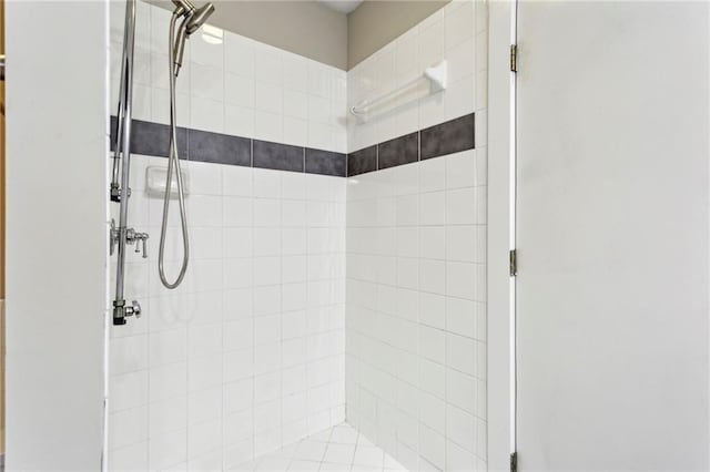 full bath with a tile shower