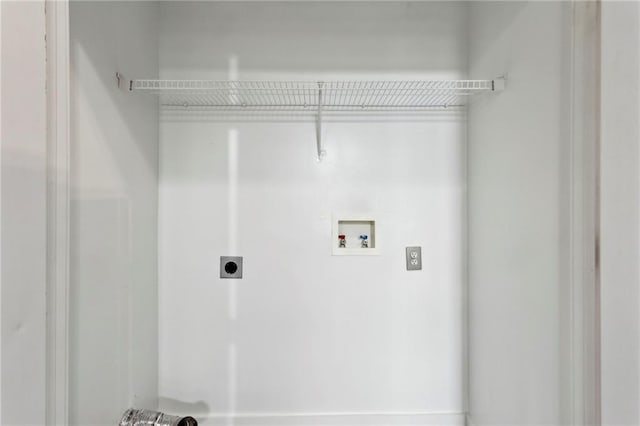 clothes washing area with hookup for an electric dryer, washer hookup, and laundry area