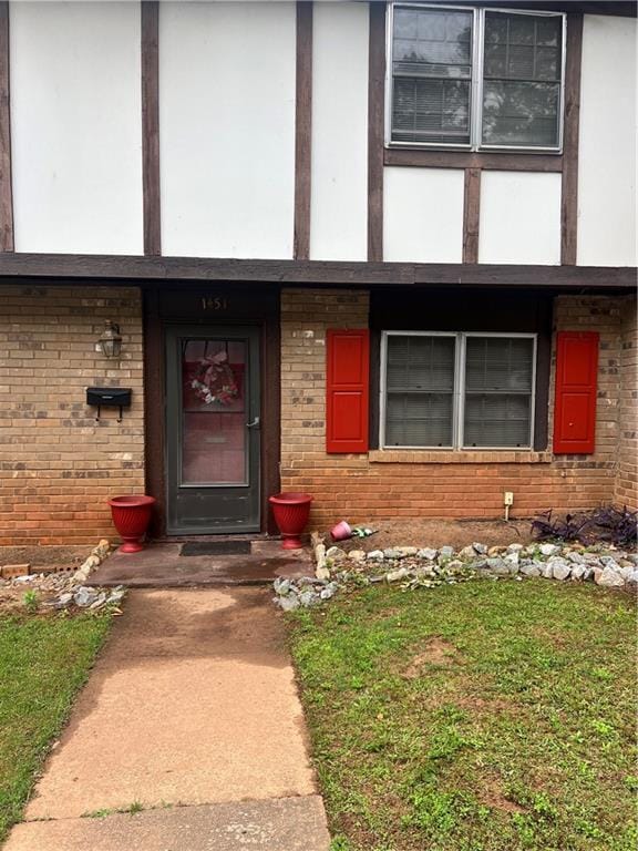 view of exterior entry with brick siding