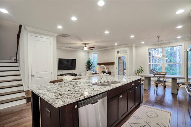 kitchen featuring a sink, dishwasher, dark wood-style floors, and dark brown cabinets