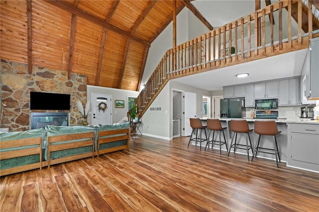182 White Eagle Dr, Waleska, GA 30183 - living room featuring high vaulted ceiling, baseboards, wood finished floors, stairway, and wooden ceiling with exposed beams