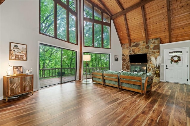 182 White Eagle Dr, Waleska, GA 30183 - living area featuring high vaulted ceiling, wood ceiling with exposed beams, healthy amount of natural light, hardwood / wood-style floors, and a stone fireplace