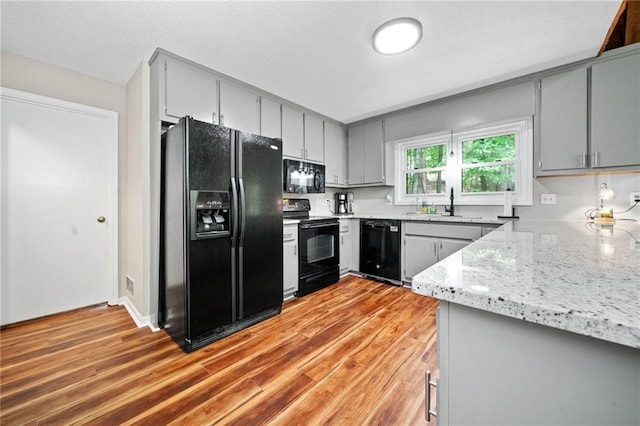 182 White Eagle Dr, Waleska, GA 30183 - kitchen featuring black appliances, gray cabinetry, and light wood finished floors