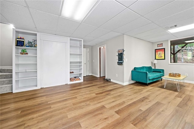 182 White Eagle Dr, Waleska, GA 30183 - sitting room with light wood-type flooring, a drop ceiling, baseboards, and built in shelves