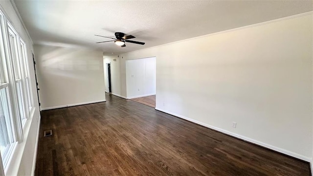 unfurnished room with a ceiling fan, visible vents, dark wood-style flooring, and baseboards