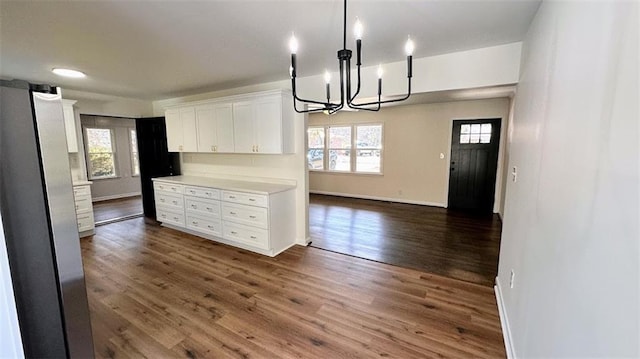 kitchen featuring plenty of natural light, dark wood-type flooring, white cabinets, and light countertops