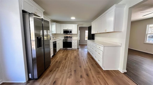 kitchen featuring plenty of natural light, appliances with stainless steel finishes, light countertops, and a sink