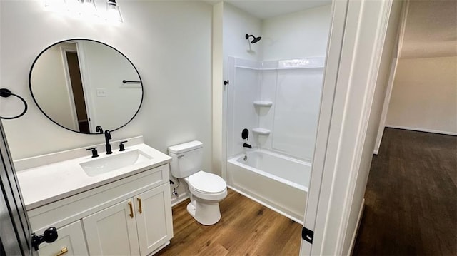 full bathroom with shower / bathtub combination, toilet, wood finished floors, and vanity