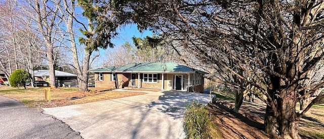 single story home with a porch and driveway