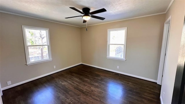 unfurnished room featuring crown molding, plenty of natural light, wood finished floors, and baseboards