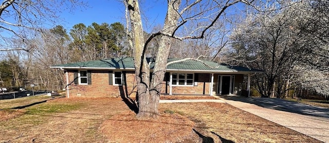 single story home featuring brick siding and driveway