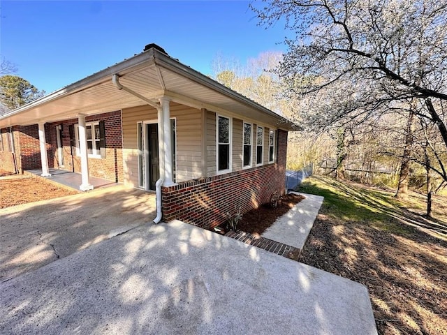 view of property exterior featuring brick siding