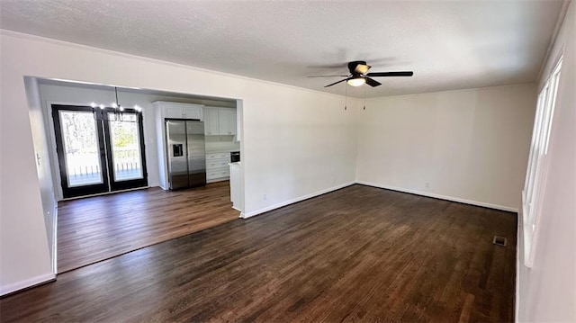 spare room with ceiling fan, dark wood-style floors, baseboards, and a textured ceiling