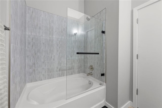 bathroom with bathtub / shower combination and baseboards