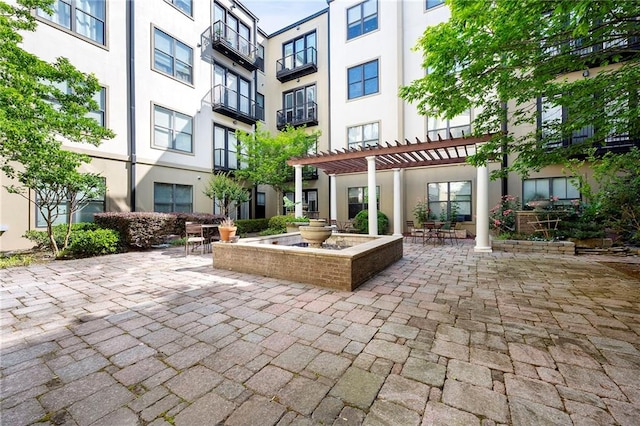 view of property's community featuring a pergola and a patio area