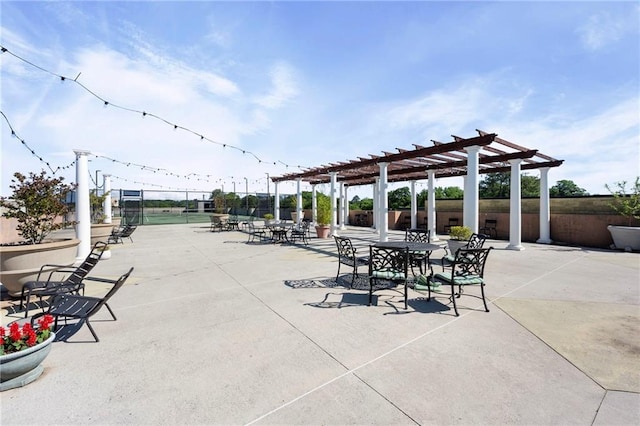 view of patio featuring a pergola and fence