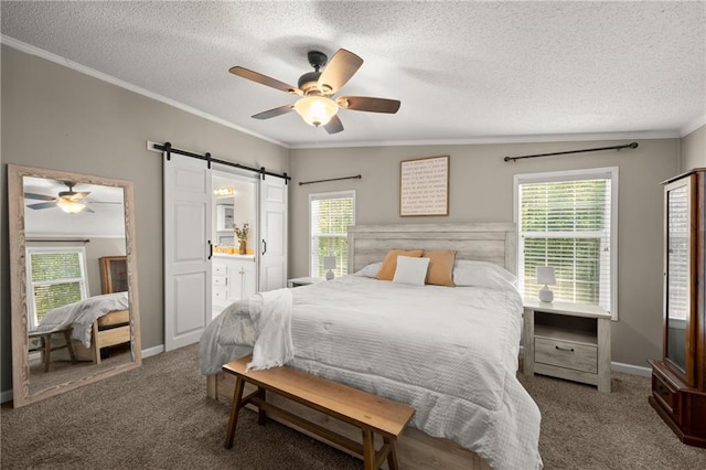 carpeted bedroom featuring ornamental molding, connected bathroom, a barn door, a textured ceiling, and ceiling fan