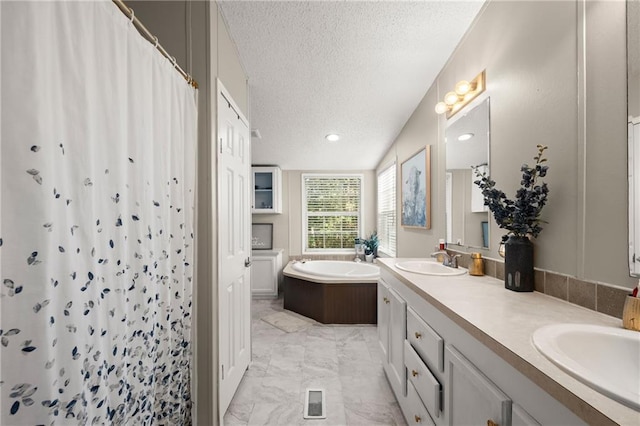 bathroom featuring vanity, walk in shower, a textured ceiling, and vaulted ceiling