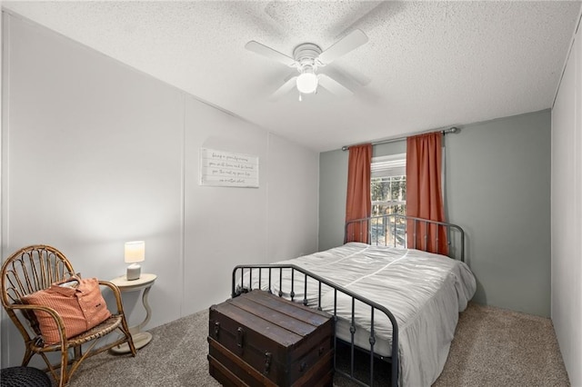 carpeted bedroom with a textured ceiling and ceiling fan