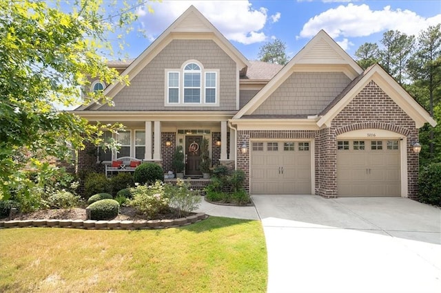 craftsman inspired home with a front yard and a garage