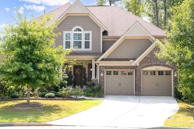 craftsman-style home with a garage and a front lawn