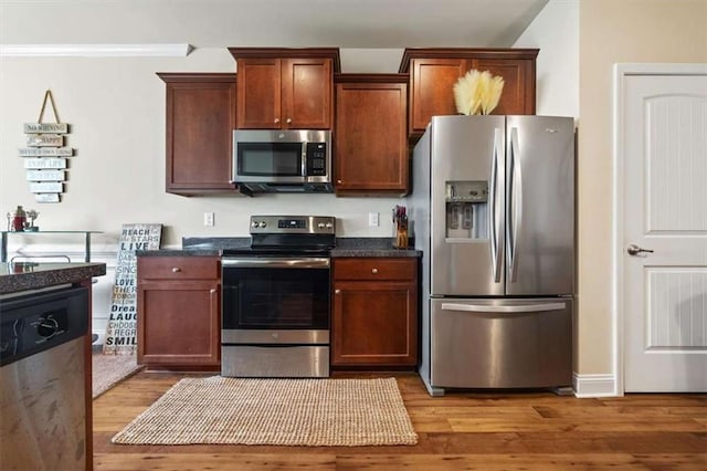 kitchen featuring stainless steel appliances and light wood-type flooring