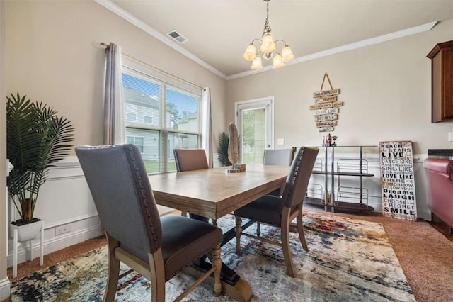 carpeted dining area featuring ornamental molding, visible vents, baseboards, and an inviting chandelier