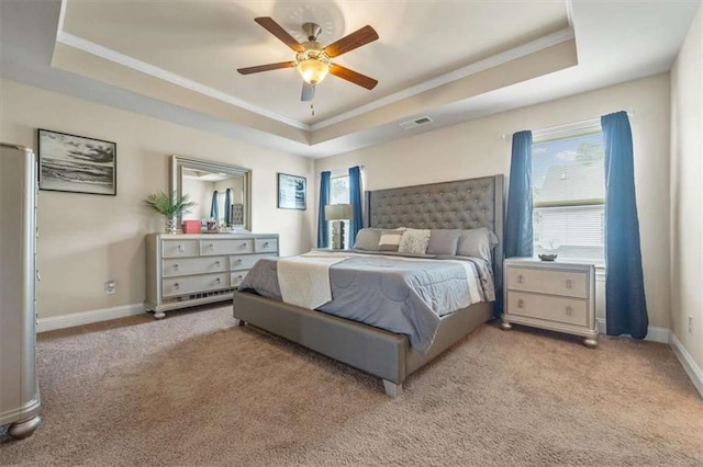 bedroom featuring a raised ceiling, multiple windows, light carpet, and baseboards