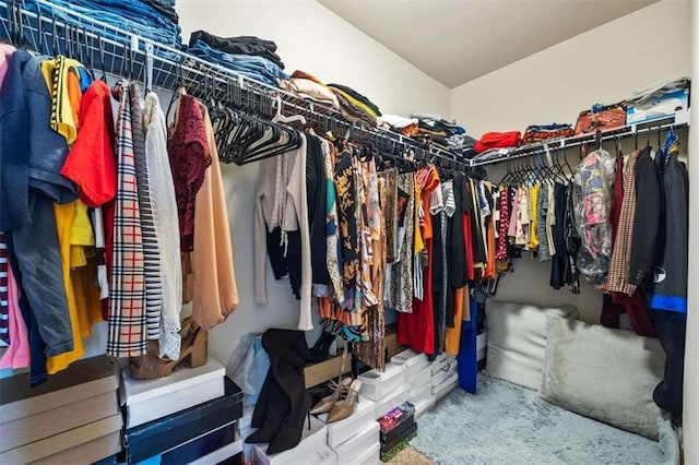 walk in closet featuring vaulted ceiling