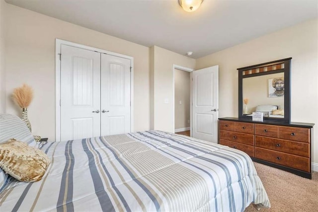 bedroom featuring carpet floors, a closet, and baseboards