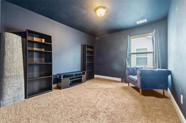 living area featuring carpet, visible vents, and baseboards