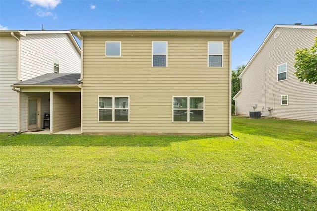 back of property with central air condition unit, a patio, and a yard