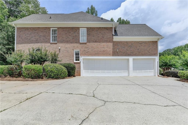 12130 Helleri Holw, Alpharetta, GA 30005 - view of side of home featuring driveway, brick siding, and an attached garage
