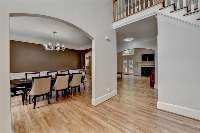 12130 Helleri Holw, Alpharetta, GA 30005 - dining room with arched walkways, wood finished floors, ornamental molding, baseboards, and a towering ceiling