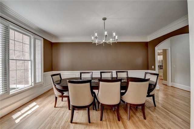 12130 Helleri Holw, Alpharetta, GA 30005 - dining room featuring a chandelier, ornamental molding, light wood finished floors, plenty of natural light, and wainscoting
