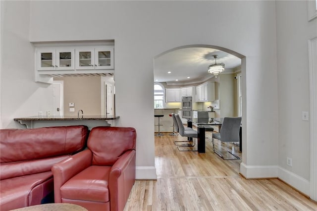 12130 Helleri Holw, Alpharetta, GA 30005 - living area featuring arched walkways, light wood-style flooring, baseboards, ornamental molding, and recessed lighting