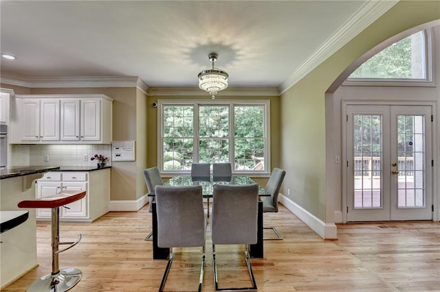 12130 Helleri Holw, Alpharetta, GA 30005 - dining room with arched walkways, light wood-type flooring, french doors, ornamental molding, and baseboards