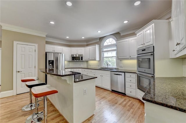 12130 Helleri Holw, Alpharetta, GA 30005 - kitchen with stainless steel appliances, a sink, white cabinets, ornamental molding, and recessed lighting