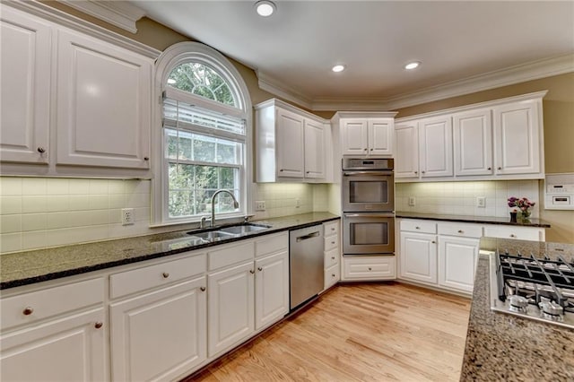 12130 Helleri Holw, Alpharetta, GA 30005 - kitchen featuring appliances with stainless steel finishes, a sink, white cabinets, ornamental molding, and recessed lighting