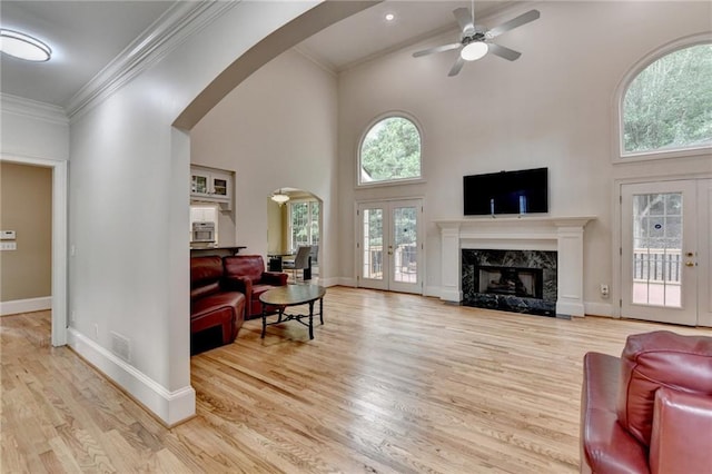 12130 Helleri Holw, Alpharetta, GA 30005 - living area featuring arched walkways, french doors, ceiling fan, wood finished floors, and high vaulted ceiling