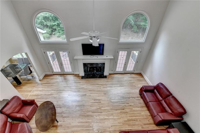 12130 Helleri Holw, Alpharetta, GA 30005 - living room featuring french doors, a high ceiling, healthy amount of natural light, and a premium fireplace