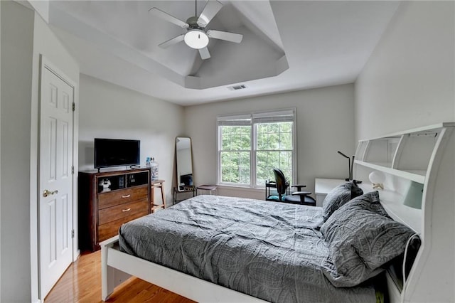 12130 Helleri Holw, Alpharetta, GA 30005 - bedroom featuring a raised ceiling, wood finished floors, and a ceiling fan