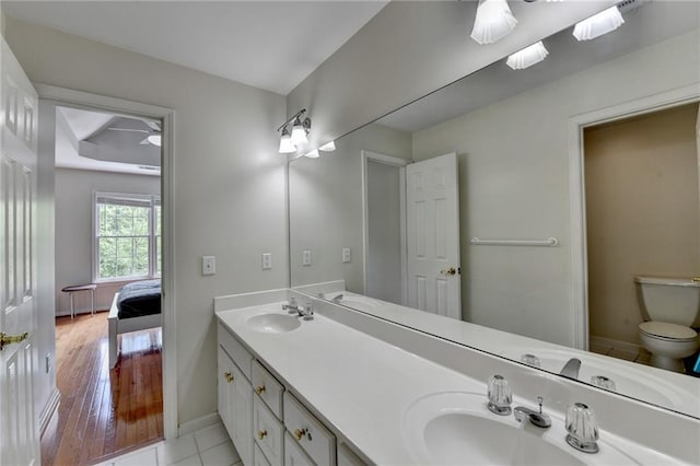 12130 Helleri Holw, Alpharetta, GA 30005 - ensuite bathroom with baseboards, double vanity, toilet, ceiling fan, and wood finished floors