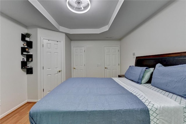 12130 Helleri Holw, Alpharetta, GA 30005 - bedroom with a tray ceiling, light wood-style flooring, and baseboards
