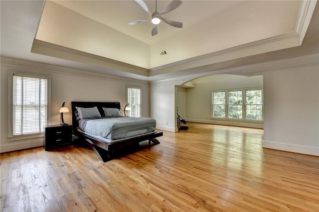 12130 Helleri Holw, Alpharetta, GA 30005 - bedroom featuring arched walkways, light wood-style floors, crown molding, and a tray ceiling
