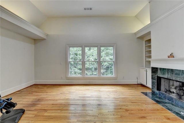 12130 Helleri Holw, Alpharetta, GA 30005 - unfurnished living room with a fireplace, vaulted ceiling, light wood finished floors, built in features, and baseboards